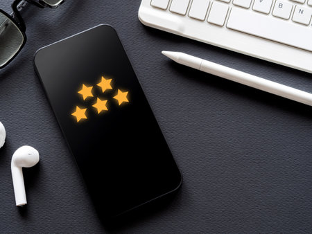 The 5-star icon on the smartphone screen is on black background. Five-star satisfaction rating and...