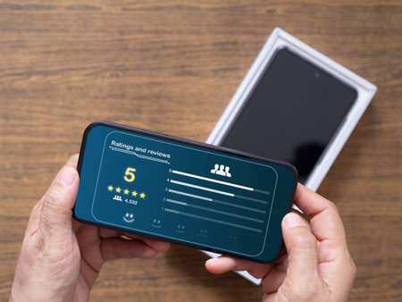 The customer send the score and feedback on the five-star rating of new cellphone. Satisfaction and service are scored through the application on the smartphone. Review, feedback survey concept.の写真素材