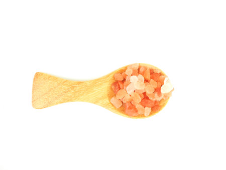 Flat lay, Top view of himalayan pink salt in wooden spoon isolated on a white background.の写真素材