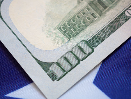 Close up, back side of American one hundred dollar bill on USA flag background. Close up, selective focus.の写真素材