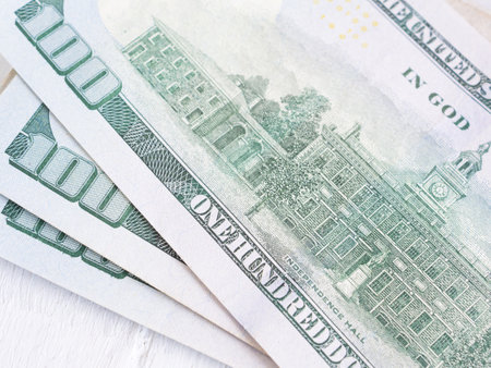 Close up, back side of American one hundred dollar bill on white wooden background. Close up, selective focus.の写真素材