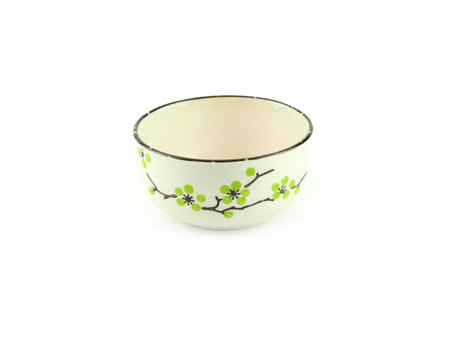 Empty beige ceramic bowl with brown rim and green flora pattern isolated on a white background. Used serving for home or restaurant, food design. Kitchen accessory.の写真素材