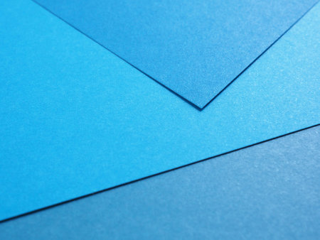 Empty gradient blue colored paper background texture. Abstract geometric flat composition. The concept for image, text, and design.の写真素材
