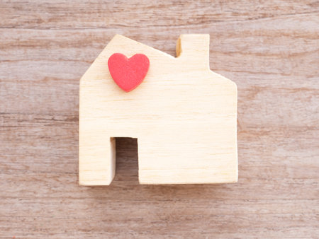 Top view house wooden toy with red heart on a rustic table. Home sweet home. Concept finance, insurance, lone.の写真素材