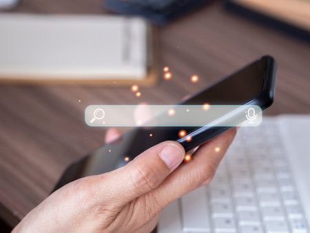 Businessman using smartphone searching browsing Internet data information and working on wooden table. data online search concept.の写真素材