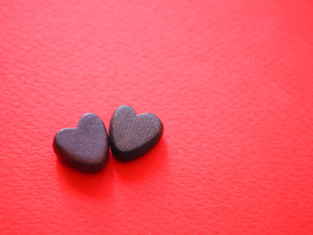 Red paper background with two brown hearts shape, Happy Valentine's day. Positive background.の写真素材