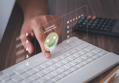 Customer services best excellent business rating experience. Satisfaction survey concept. A smile face icon on virtual screen over the keyboard computer. 5 Star Satisfactionの写真素材