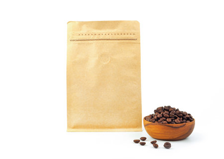 Brown craft paper bag with vacuum-sealed, zipper, wooden bowl for packaging roasted coffee beans template isolated on a white background. Package mock-up for coffee or dry seeds product.の写真素材