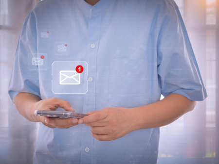 Person send or receive e-mail from notification icon by smartphone. Business communication, internet, and technology.の写真素材