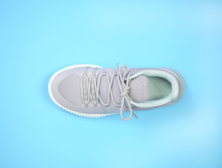 New Grey-light green sneakers isolated on blue background. Unisex sports footwear, fashion style pair of casual sports shoes, Mock-up for sneaker design, logo, a product of sport.の写真素材
