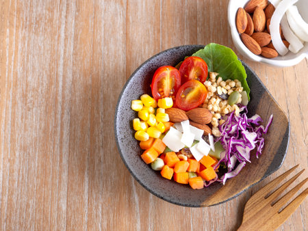 Healthy food and  weight loss concept. Homemade mixed salad, almond in old clay bowl on wooden background. Top view, with copy space.の写真素材