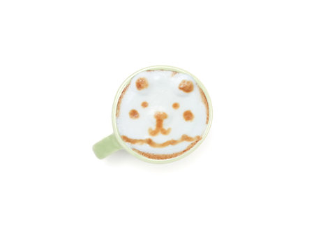Hot latte coffee with art face bears shape in a green ceramic mug isolated on a white background. Top view, flat lay with space for your text.の写真素材