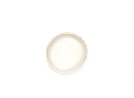 Top view, empty beige round ceramic bowl of sauce with dotted isolated on a white background. Use for home or restaurant, food design. Kitchen accessory.の写真素材