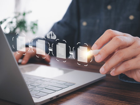 Businessman working on laptop show virtual screen icon Document Management System (DMS) working in the office, searching and managing files online document database. Internet technology concept.の写真素材