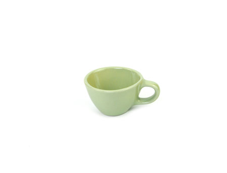 Side view, empty light-green mug isolated on white background. Blank  light green ceramic cup mockup and template for design, and banner. Use for home or restaurantの写真素材