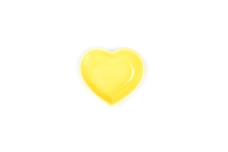 Top view, yellow heart-shaped bowls isolated on a white background.の写真素材