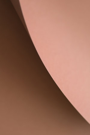 Brown paper backdrop. Close-up, abstract textured surface brown (mocha mousse) paper background. Geometric composition. Concept for image, text, design, banner, wallpaperの写真素材