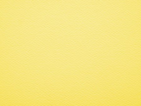 Close-up, straight-on shot of a solid, yellow paper has a visible, slightly rough texture with small, irregular fibers. Blank yellow paper background.の写真素材