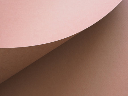 Close-up, high-angle shot featuring two overlapping sheets of textured paper in contrasting shades of tan. Concept for text, banner, wallpaper, festive.の写真素材