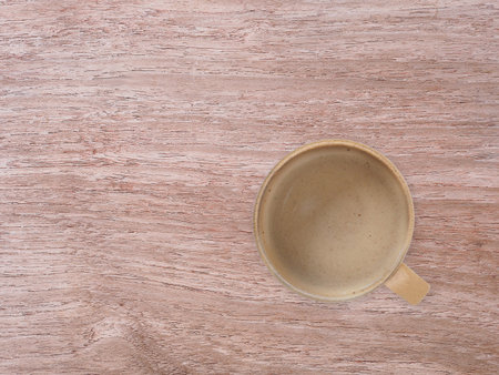 Top view of hot coffee in a brown coffee cup on wooden background, with copy space. Concept for a banner, cafe, or coffee menu.の写真素材