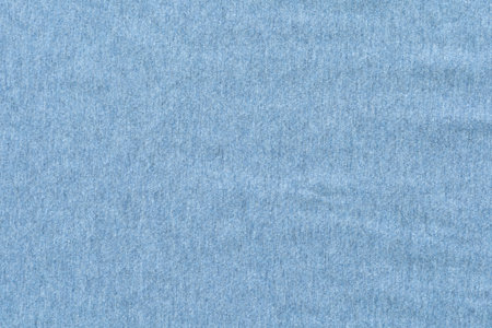 A close-up shot of soft, flowing cotton fabric in a warm light blue tone. Copy space for your text and design. Textile concept and soft backdrop, Flat layの写真素材