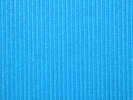 Top view, blank textured, vibrant blue corrugated cardboard surface. The distinct parallel ridges and grooves run vertically across the frame. Concept for design, image, text, and banner.の写真素材