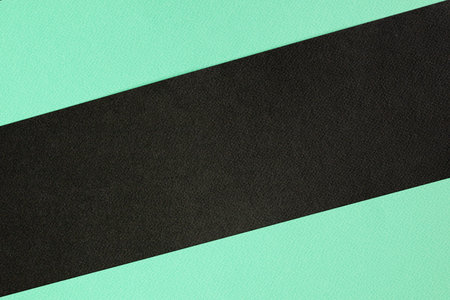 Concept for image, text, and design. Geometric paper backdrop. Two-tone color green and black colored paper background.の写真素材