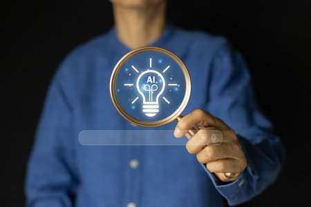 A person holding a magnifying glass over a glowing light bulb with the "AI" icon inside, representing the concept of artificial intelligence, innovative ideas, and discovering new solutions.の写真素材