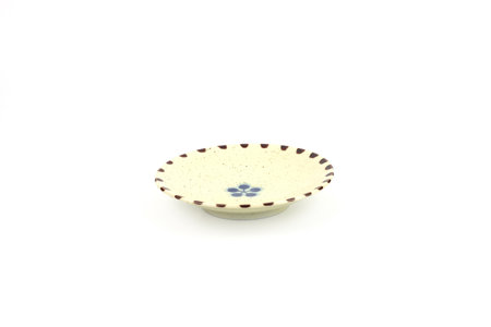 A beautifully crafted, hand-painted ceramic pedestal dish featuring a delicate floral design and unique spotted glaze isolated on white baclground. ideal for lifestyle, food, and product photography.の写真素材