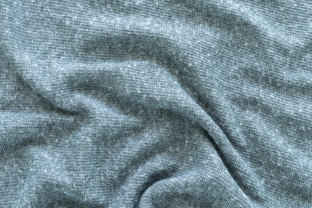 Textile concept and soft backdrop, Flat lay A close-up shot of soft, flowing fabric in a warm dark grey tone. Copy space for your text and design.の写真素材