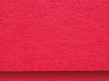 Close-up, high-angle view of a vibrant red felt fabric background. Concept for design, image, text and banner.の写真素材
