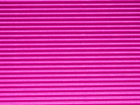 Top view, surface of bright pink corrugated cardboard background. Concept for design, image, text and banner.の写真素材