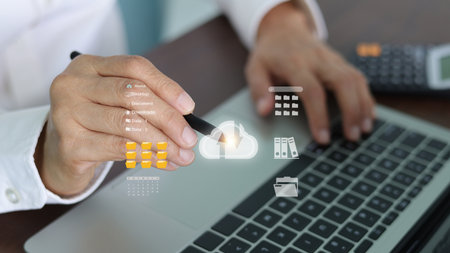 Businessman manages document system via cloud computing technology. Professional uploads and downloads files to online storage for data backup and security. Concept of database transfer.の写真素材
