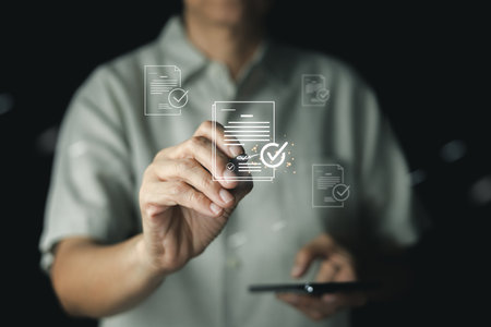 A businessman uses a stylus on a virtual interface for document management, approving an electronic contract with a digital signature for quality assurance, standard compliance, and ISO certification.の写真素材