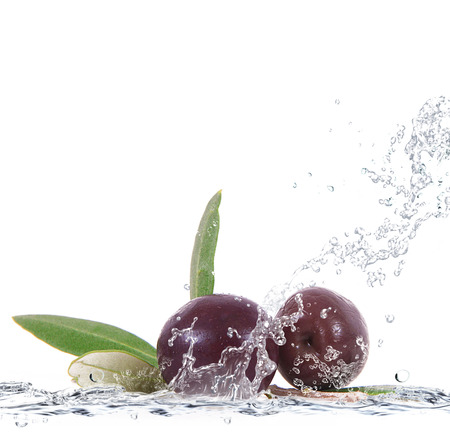 fresh olives falling in pure waterの写真素材