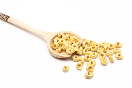 wood spoon with italian raw pasta on white backgroundの写真素材