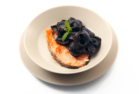 original italian ravioli with squid ink and salmonの写真素材