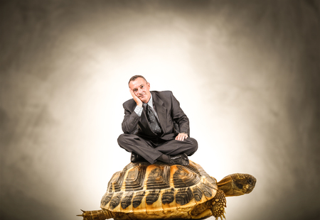 Manager sitting on a turtleの写真素材