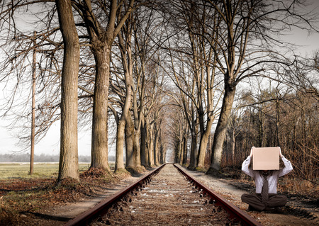person sitting along the railwayの写真素材