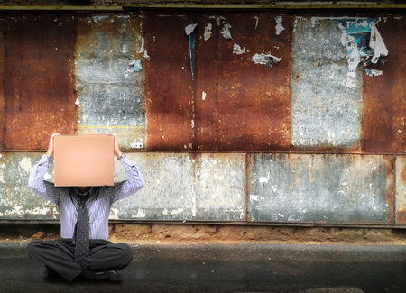 business man sitting on the roadの写真素材
