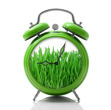 isolated alarm clock with grass dial on white backgroundの写真素材