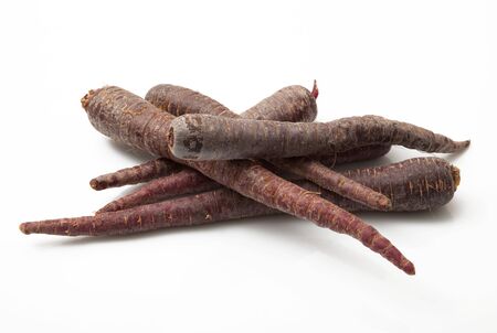 fresh black carrots on white backgroundの写真素材