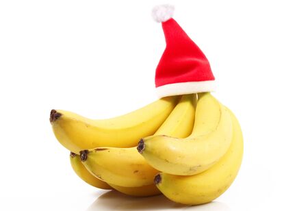 fresh bananas on white background with chistmas hatの写真素材