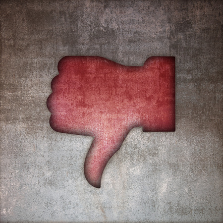 Thumbs down to indicate denialの写真素材