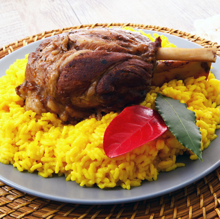 Roast shank with yellow rice with saffronの写真素材