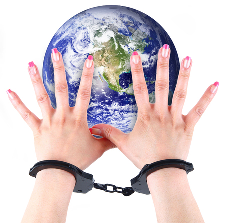 the planet Earth with hands and handcuffsの写真素材