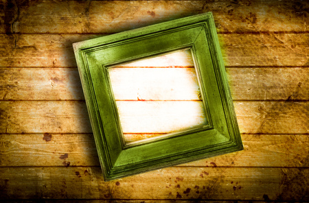 Old frame hanging on wooden wallの写真素材