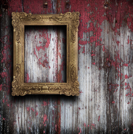 Old frame hanging on wooden wallの写真素材