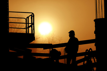 men at work in incredible sunsetの写真素材