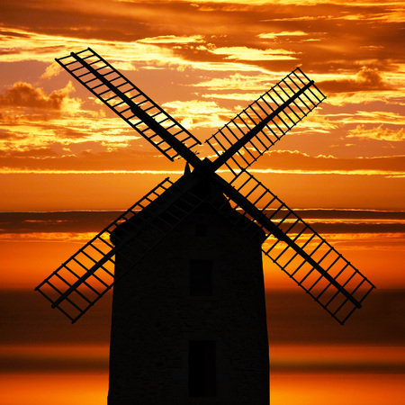 an Ancient Windmill at sunsetの写真素材